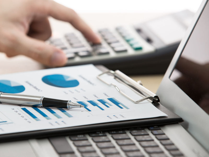 23645858 - businessman analyzing investment charts with laptop